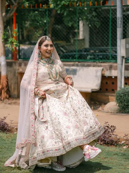 A fun and playful shot of the bride showing off her sneakers under her lehenga! It’s a perfect example of a modern bride who blends tradition with her own unique style.