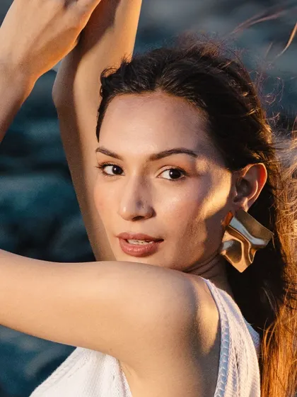 A close-up of the fresh, sun-kissed look. The skin is glowing, the brows are natural, and the lips have just a hint of color.