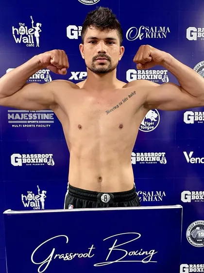 A fighter shows off his physique, a result of a grueling training camp.