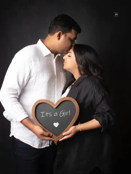 A sweet and intimate "It's a Girl" announcement. The dark background makes the couple's connection the main focus of this beautiful memory.