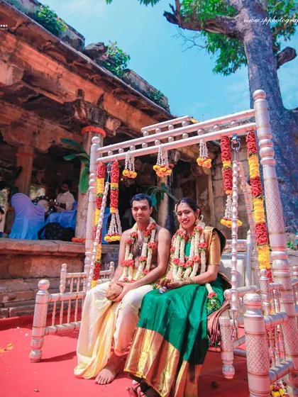 A stunning wide-angle shot of the couple during their ceremony at a temple. This photograph captures the grandeur of the location and the sacredness of the occasion.