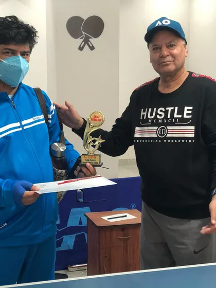 Presenting one of our third-place winners with his trophy and certificate. In our tournaments, we recognize multiple top spots to honor the high level of competition.