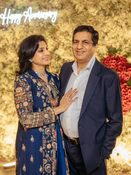 The happy couple celebrating their 30th anniversary in front of the custom floral wall I designed for them. Creating personal and meaningful backdrops for milestone moments is at the heart of what I do.