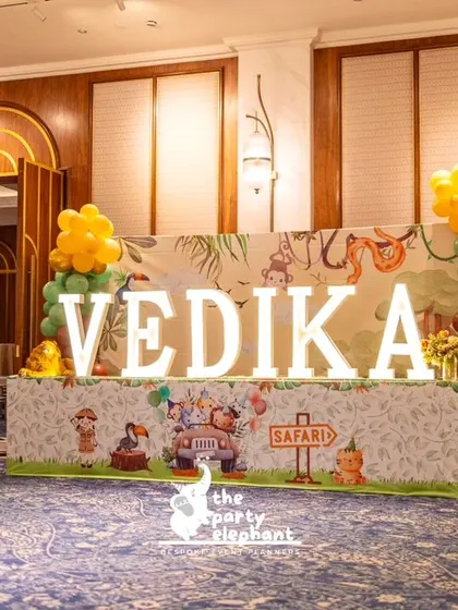 A wider view of the marquee letters and safari-themed table, showing how it served as a central decorative element within the large party venue.