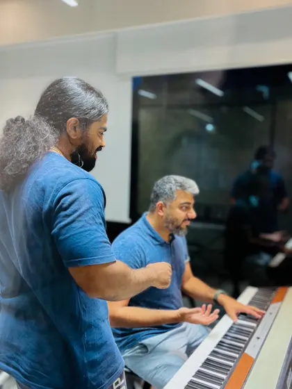 An instructor guides an adult student through a piano piece. It's never too late to start your musical journey, and we offer tailored lessons for learners of all ages.