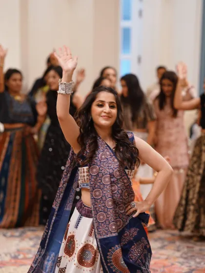 Leading the group in a Garba routine. I guide you through every step, ensuring the whole group moves together in beautiful synchrony.