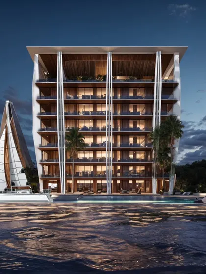 The Koh Lanta serviced apartments at night. This modern tropical retreat blends clean cubic forms and expansive glass facades with natural tones, creating a structure that breathes with the island’s coastal landscape.