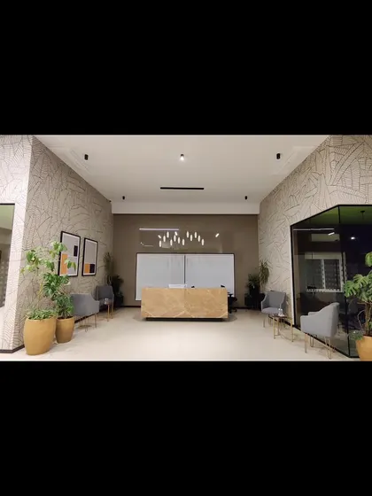 This large-scale line art mural covers two walls in a modern office reception. The repeating leaf pattern adds texture and visual interest without overwhelming the space.