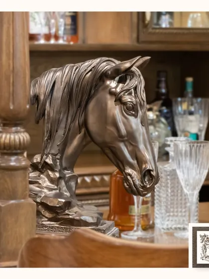 This bronze-finished horse head statue adds a touch of classic, equestrian charm to a bar or study. Its detailed craftsmanship makes it a sophisticated accent piece for any collector.