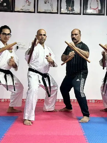 A dynamic group pose with Tonfa, showcasing the stances and readiness associated with this traditional Okinawan weapon.