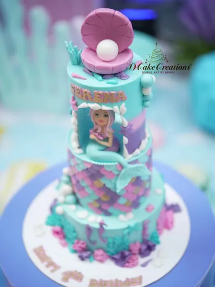 Another angle of the detailed mermaid cake, showing the texture of the scales and the variety of edible sea life decorations.