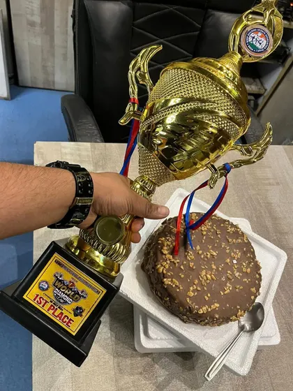 After the win comes the celebration. A well-earned cake for our champion, because balancing intense discipline with reward is part of the journey.