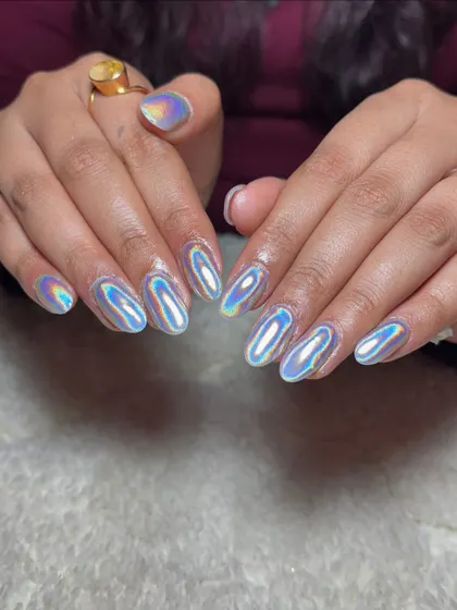 For a futuristic and eye-catching vibe, I used a special holographic chrome powder over these almond-shaped extensions. The way they shift colors in the light is just mesmerizing.