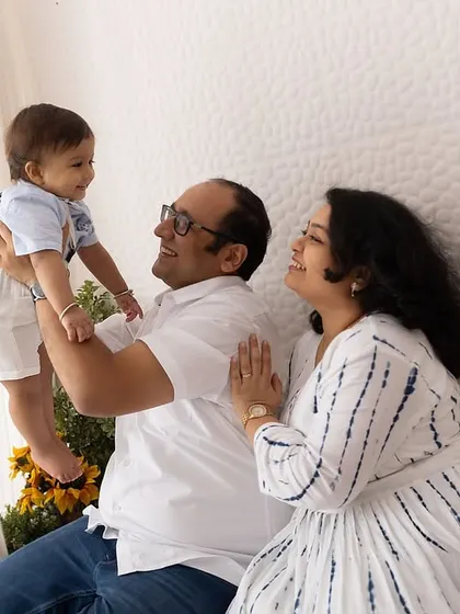 Lifting him high! A playful and joyous moment between parents and their baby boy in the studio.