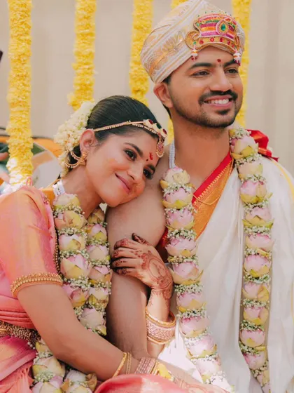 Sowmya resting her head on Skandha's shoulder, a simple, sweet, and intimate portrait from their wedding day.