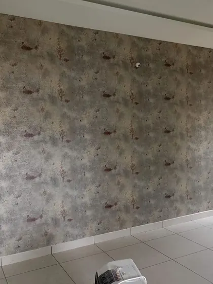 A textured wallpaper with a subtle fish pattern.