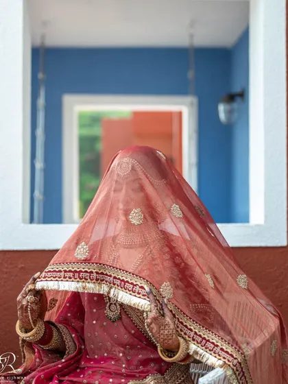 A beautiful bridal portrait showing the bride's veil, adding a touch of mystery and tradition.