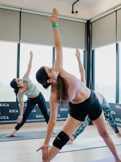 Students flowing through Trikonasana, or Triangle Pose, during our International Yoga Day event. It's beautiful to see a room full of people moving in sync.