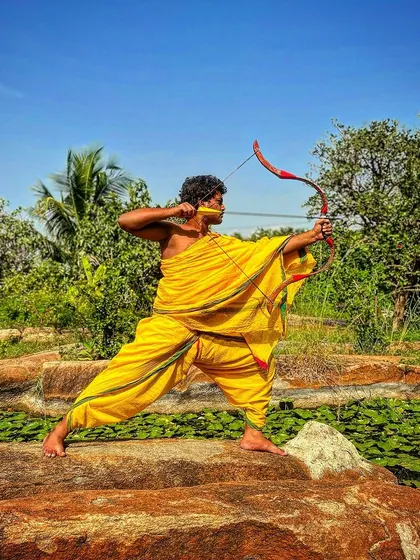 A warrior's greatest weapon is a mind sharpened by discipline. This stance, taken in nature, reflects the connection between the archer and the elements, a core concept in Vedic warrior philosophy.