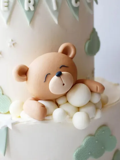 A close-up of the adorable sleeping teddy bear figurine.
