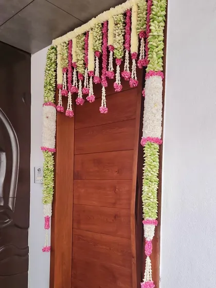 Varamahalakshmi habba shubhashayagalu. For the festival, I created this beautiful door decoration, or 'tomale', using traditional flowers and leaves to welcome the goddess into the home.