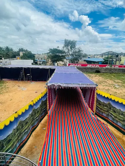 A large-scale outdoor setup in Chitradurga. We can provide tents and covered walkways to create a comfortable dining space for your guests, no matter the location.