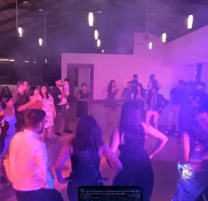 The dance floor is lit in purple, creating a cool party vibe.