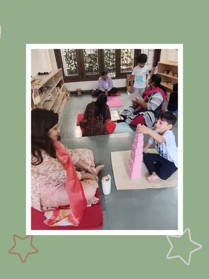 Building the pink tower requires concentration and precision. Tavish shows his mother how he has mastered this sensorial activity, a visible sign of his developing cognitive skills.