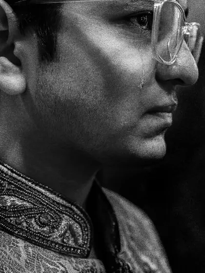 A tear rolls down the cheek of the groom's brother during the Vidaai. It's a powerful testament to the bonds of family and the emotion of the day.