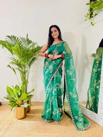 I love the rich color of this green organza saree. The delicate embroidery and border detail make it a beautiful choice for any party or festive event. It's a lightweight option that still looks very grand.