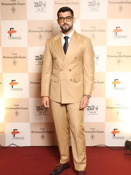 The epitome of red-carpet style. This guest's confident stance in his bespoke Zegna suit showcases the flawless fit and powerful silhouette we achieve for our clients.