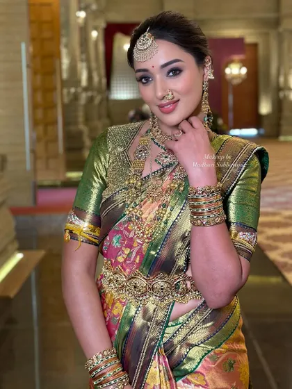 A playful and confident pose. The makeup is designed to make a statement while still feeling elegant and appropriate for a traditional wedding.