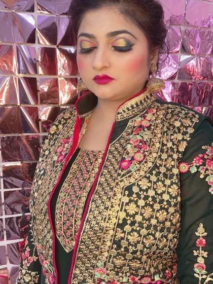 A close-up of the dramatic eye makeup for the party guest in the green outfit.