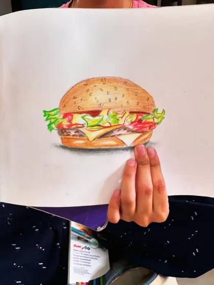 A delicious-looking burger drawn with color pencils. It's so much fun to draw your favorite foods.