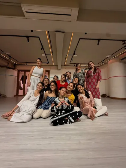 A happy group photo with my students after a class. The community and family we build in the studio is the most important part of my work.