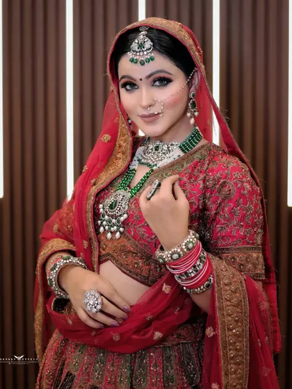 A confident and poised portrait. The bride's hand gesture draws attention to her stunning statement ring and the intricate details of her lehenga.