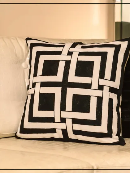 Discover untamed sophistication with this black and white cushion featuring an interlocking geometric pattern. Part of the Wild Noir collection, it brings power and poise into your space.