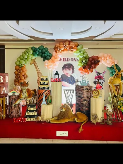 We can customize our jungle theme to fit your vision. This setup for Kashvi's "Wild One" party includes a mix of cartoon and plush animals, creating a playful and inviting atmosphere on stage.