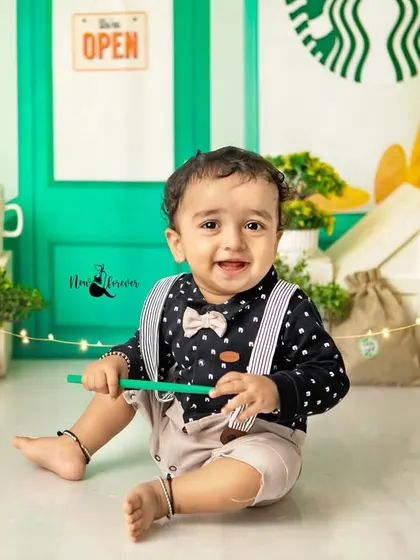A happy smile from the best barista around. His adorable outfit with a bow tie and suspenders completes the look perfectly.