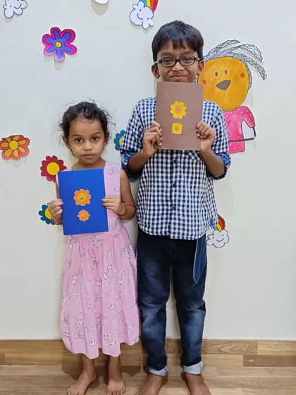 Two siblings proudly display the smiling sun cards they created. Our camp is a great place for brothers and sisters to learn and create together.