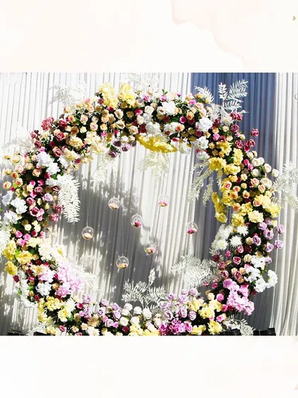 A romantic floral circle serves as a perfect photo booth or backdrop. We love creating these little corners of bliss for guests to capture memories.