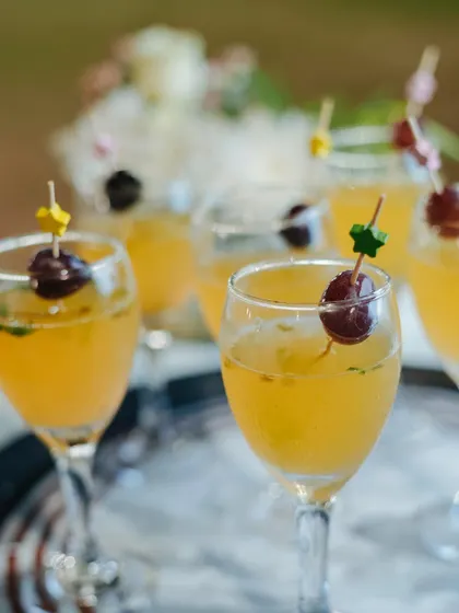 A tray of our elegant mocktails, garnished with grapes. We believe that drinks should be as thoughtfully crafted and presented as the food.