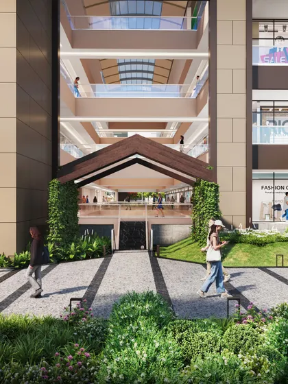 A detailed shot of a shopping mall entrance. This rendering highlights the integration of green spaces and pedestrian pathways leading into the retail center.