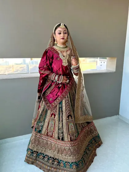 This bride's look is regal and timeless. The makeup complements her multi-toned lehenga, with a focus on flawless skin and defined features.