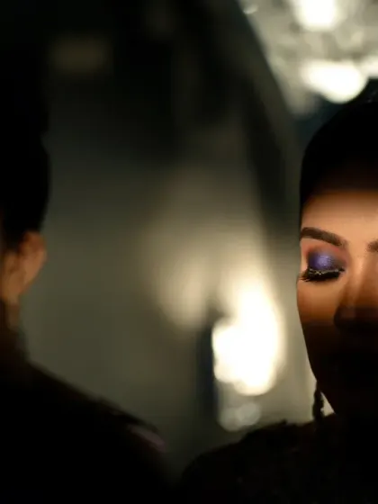 An artistic shot focusing on the bride's dramatic eye makeup, using reflections and shadows for a creative and moody effect.