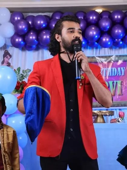 Two young assistants on stage, ready to be part of the magic show.