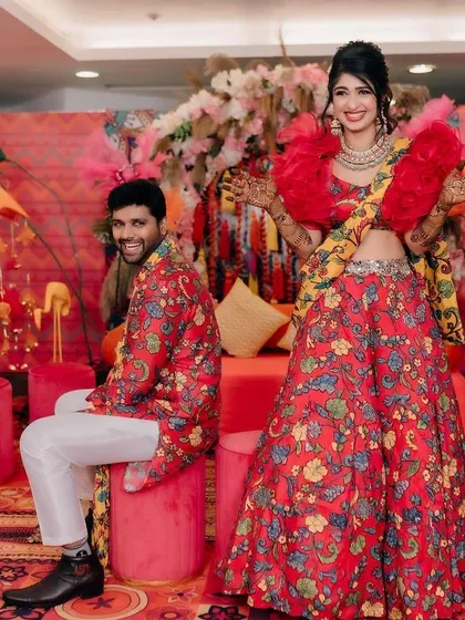 Fun and candid moments from a vibrant Mehendi event. The couple is sharing a laugh, surrounded by the bright, festive atmosphere I designed for their special day.