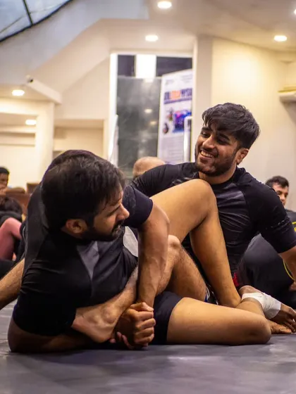Two students drilling a leg lock submission. The seminar environment is about focused learning and helping your training partners improve.