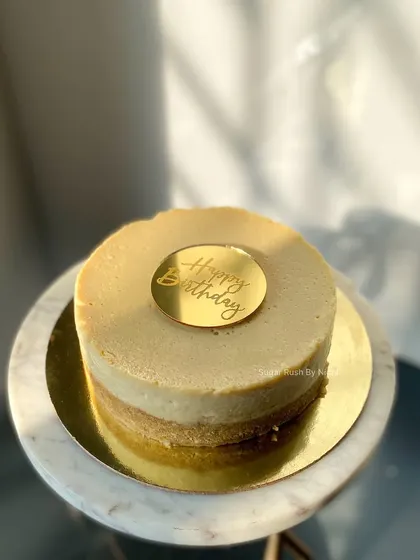 A classic NY Style Baked Cheesecake. It's rich, creamy, and 100% eggless, with a simple "Happy Birthday" topper for a touch of celebration.