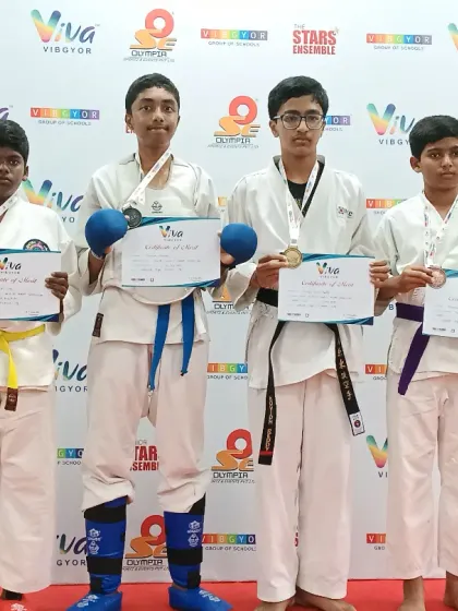 Proudly displaying their medals and certificates. These students represent different belt levels but share the same champion mindset.
